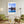 Descriptive Minimalist Chicago Skyline Poster in Wooden Frame displayed in a living room with green chairs.