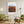 Descriptive Minimalist Texas Poster in Wooden Frame displayed in a living room with green chairs.