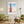 Descriptive Minimalist San Francisco Poster in Wooden Frame displayed in a living room with green chairs.