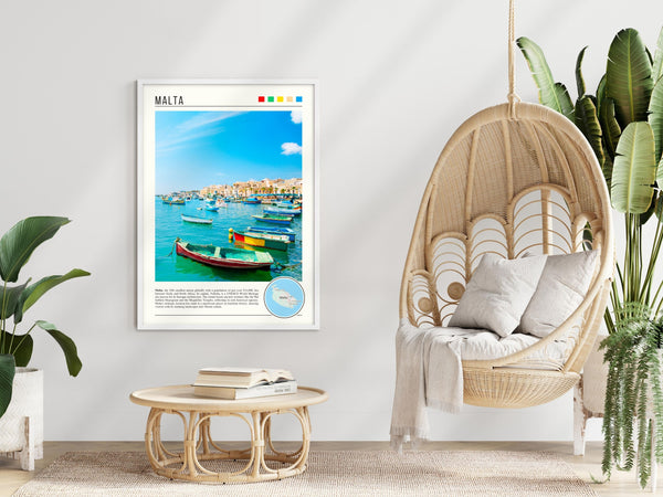 Descriptive Minimalist Malta Poster in White Frame displayed in a modern living room with a wicker chair.