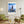 Descriptive Minimalist Willis Tower Poster in Wooden Frame displayed in a living room with green chairs.