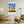 Descriptive Minimalist San Francisco Poster in Wooden Frame displayed in a living room with green chairs.