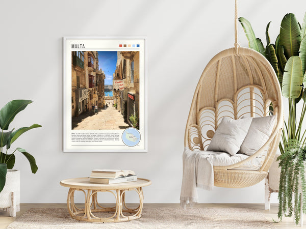 Descriptive Minimalist Malta Poster in White Frame displayed in a modern living room with a wicker chair.