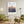 Descriptive Minimalist New York Poster in Wooden Frame displayed in a living room with green chairs.