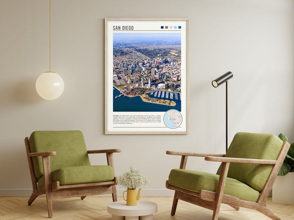 Descriptive Minimalist San Diego Poster in Wooden Frame displayed in a living room with green chairs.