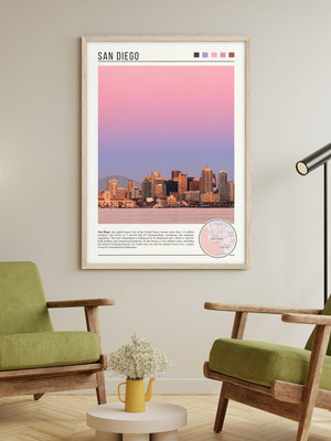 Descriptive Minimalist San Diego Poster in Wooden Frame displayed in a living room with green chairs.