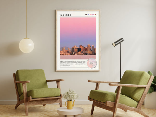 Descriptive Minimalist San Diego Poster in Wooden Frame displayed in a living room with green chairs.