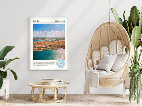 Descriptive Minimalist Malta Poster in White Frame displayed in a modern living room with a wicker chair.