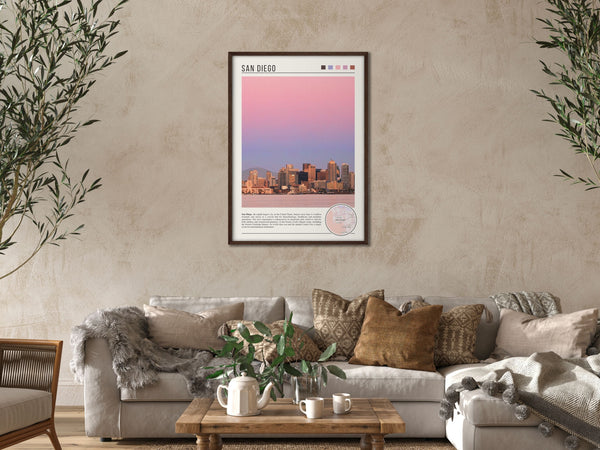 Descriptive Minimalist San Diego Poster in Dark Wooden Frame displayed in a cozy living room with a beige sofa.