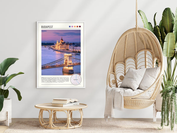 Descriptive Minimalist Budapest Poster in White Frame displayed in a modern living room with a wicker chair.