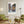 Descriptive Minimalist San Francisco Poster in Wooden Frame displayed in a living room with green chairs.