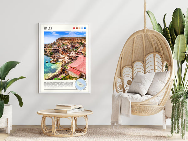 Descriptive Minimalist Malta Poster in White Frame displayed in a modern living room with a wicker chair.