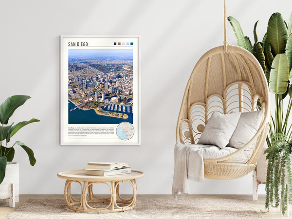 Descriptive Minimalist San Diego Poster in White Frame displayed in a modern living room with a wicker chair.