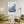 Descriptive Minimalist San Francisco Poster in Wooden Frame displayed in a living room with green chairs.