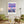 Descriptive Minimalist New York Poster in Wooden Frame displayed in a living room with green chairs.