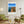 Descriptive Minimalist San Diego Poster in Wooden Frame displayed in a living room with green chairs.