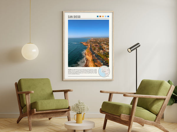 Descriptive Minimalist San Diego Poster in Wooden Frame displayed in a living room with green chairs.