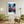 Descriptive Minimalist New York Poster in Wooden Frame displayed in a living room with green chairs.