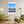 Descriptive Minimalist San Francisco Poster in Wooden Frame displayed in a living room with green chairs.