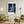 Descriptive Minimalist New York Poster in Wooden Frame displayed in a living room with green chairs.