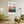 Descriptive Minimalist San Francisco Poster in Wooden Frame displayed in a living room with green chairs.