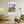 Descriptive Minimalist Boston Poster in Wooden Frame displayed in a living room with green chairs.