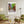 Descriptive Minimalist Boston Poster in Wooden Frame displayed in a living room with green chairs.